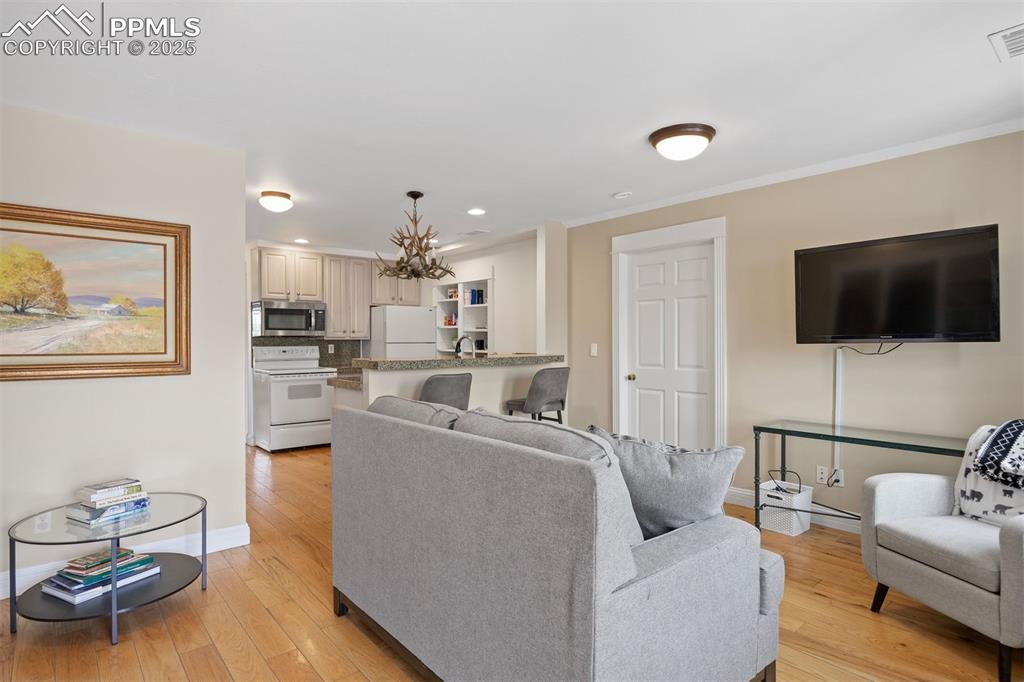 Image 42 of 49: Located above the detached garage, the two bedroom apartment features a ful