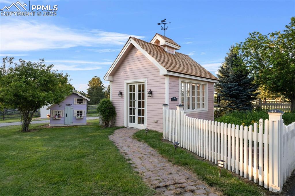 Image 43 of 49: Charming garden cottage.