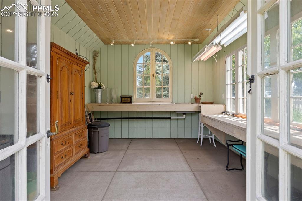 Image 44 of 49: The garden cottage includes running water and electricity, and features a n