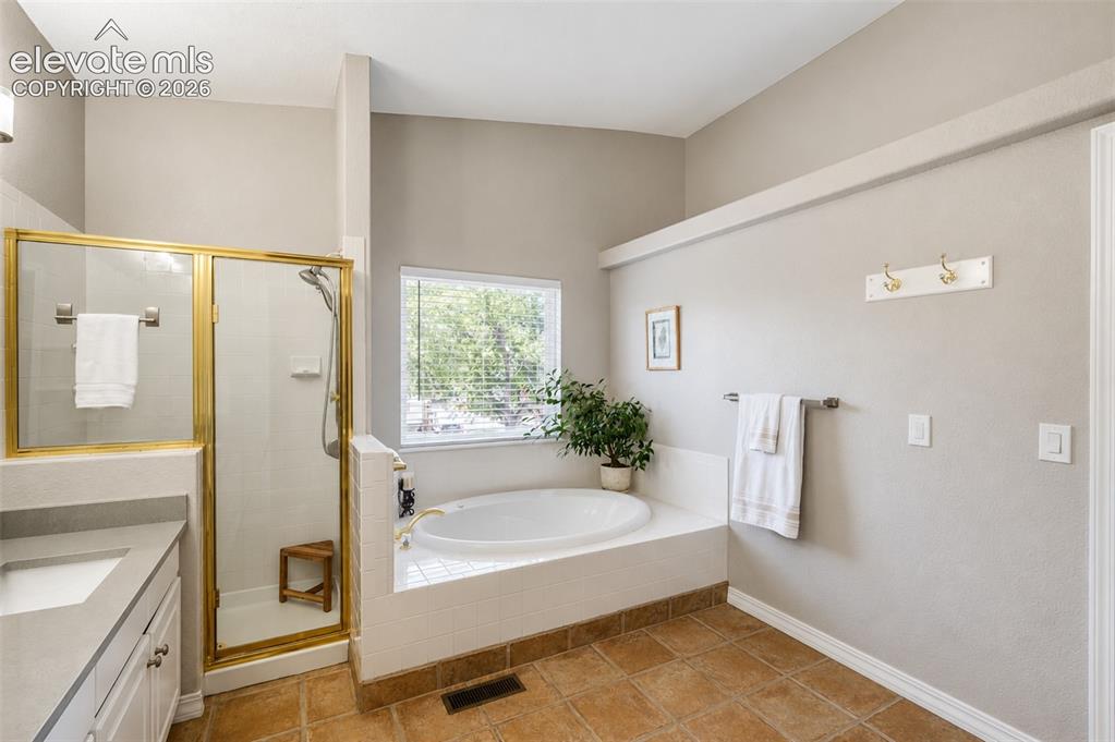 Image 13 of 50: Primary bathroom (1) five piece bath - main floor
