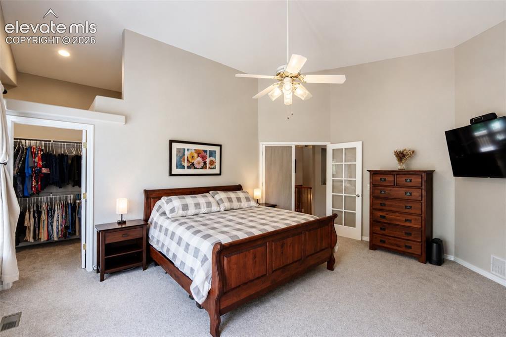 Image 9 of 50: Primary bedroom (1) with walk in closet, walk out balcony deck, and ensuite