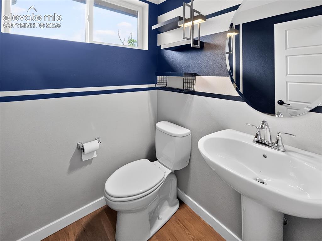 Image 13 of 50: Pedestal sink with chrome faucet set against a contemporary wall design, fe