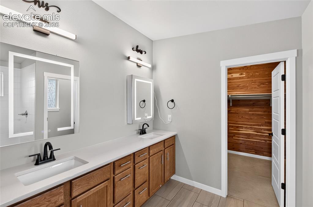 Image 18 of 50: Adjacent to Master Bedroom and walk in closet Double vanity with integrated