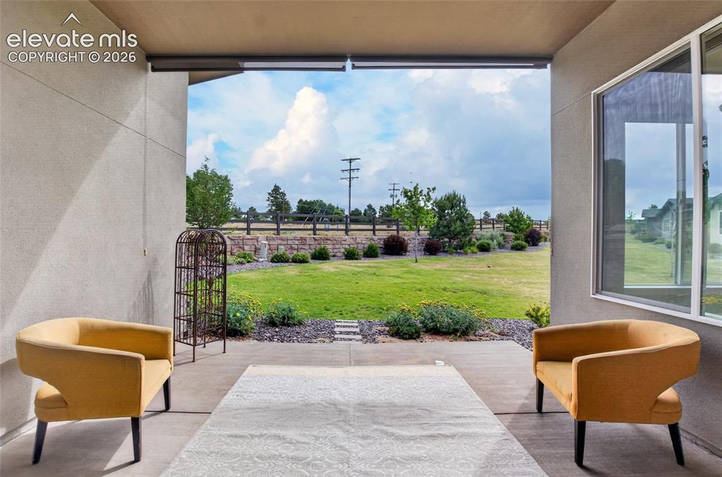 Image 44 of 50: Covered patio with concrete flooring