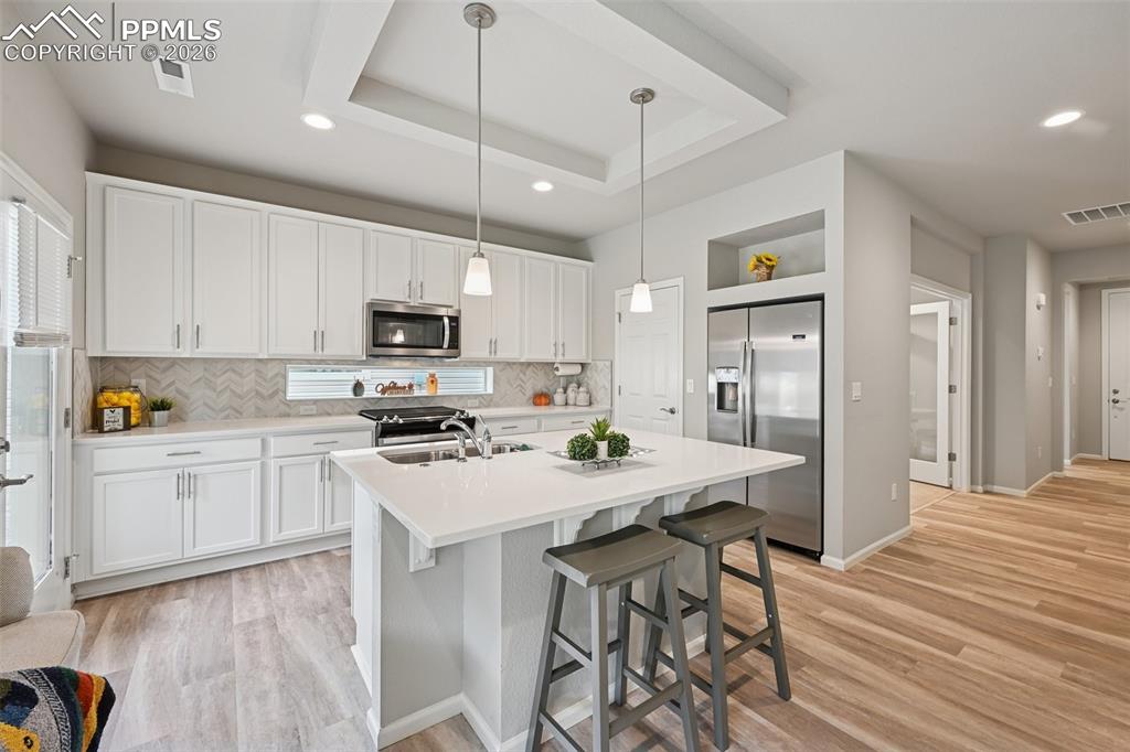 Image 10 of 32: Solid surface countertops, large pantry and walk-out to patio.