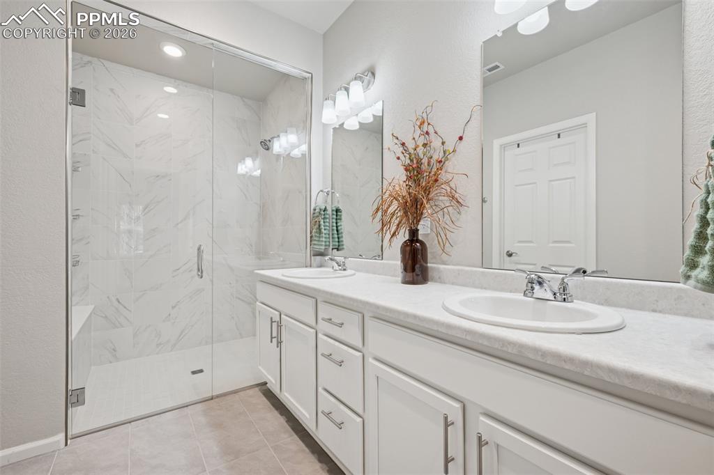Image 15 of 32: Primary Bathroom with double sink and large walk-in shower