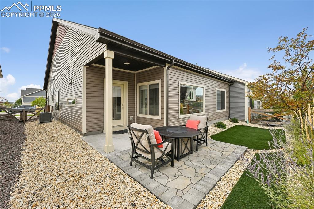 Image 20 of 32: Entertain from the covered patio that expands to the open patio.