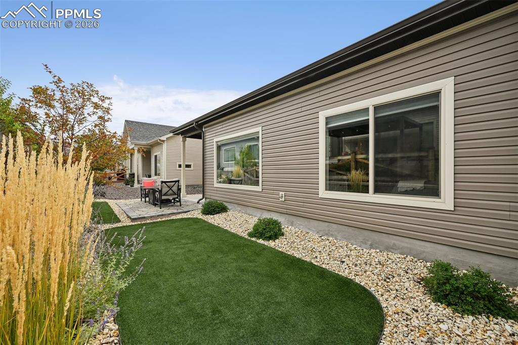 Image 22 of 32: Turf, rock and pavers create an easy care backyard.