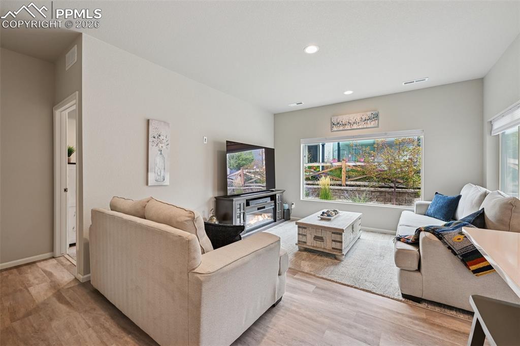 Image 8 of 32: Bright, open living room with neutral colors.