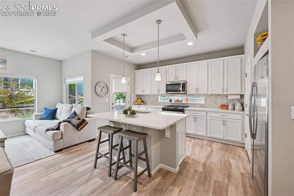 Image 9 of 32: Kitchen area with island, tons of cabinet space, gas range, dishwasher and 