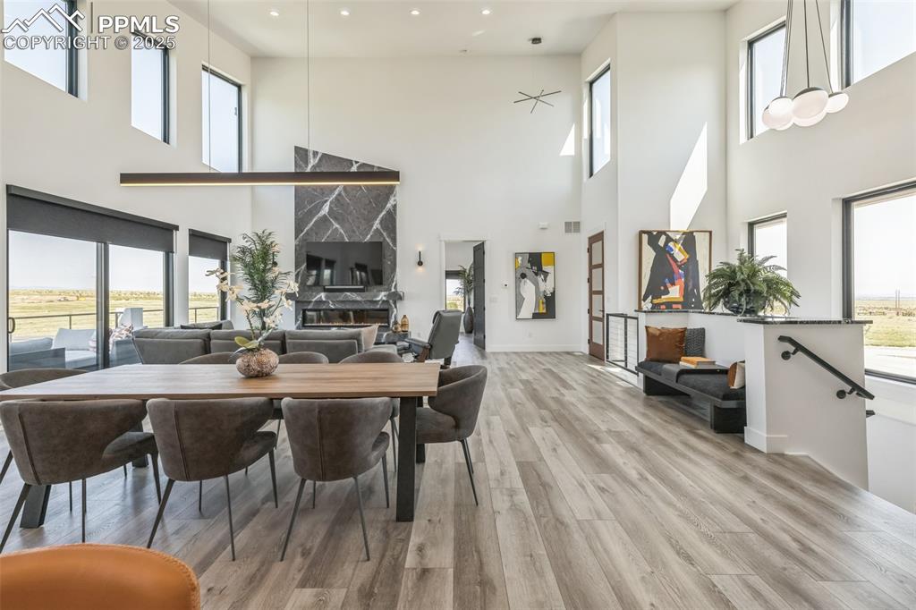 Image 10 of 50: Dining area with healthy amount of natural light and wood finished floors
