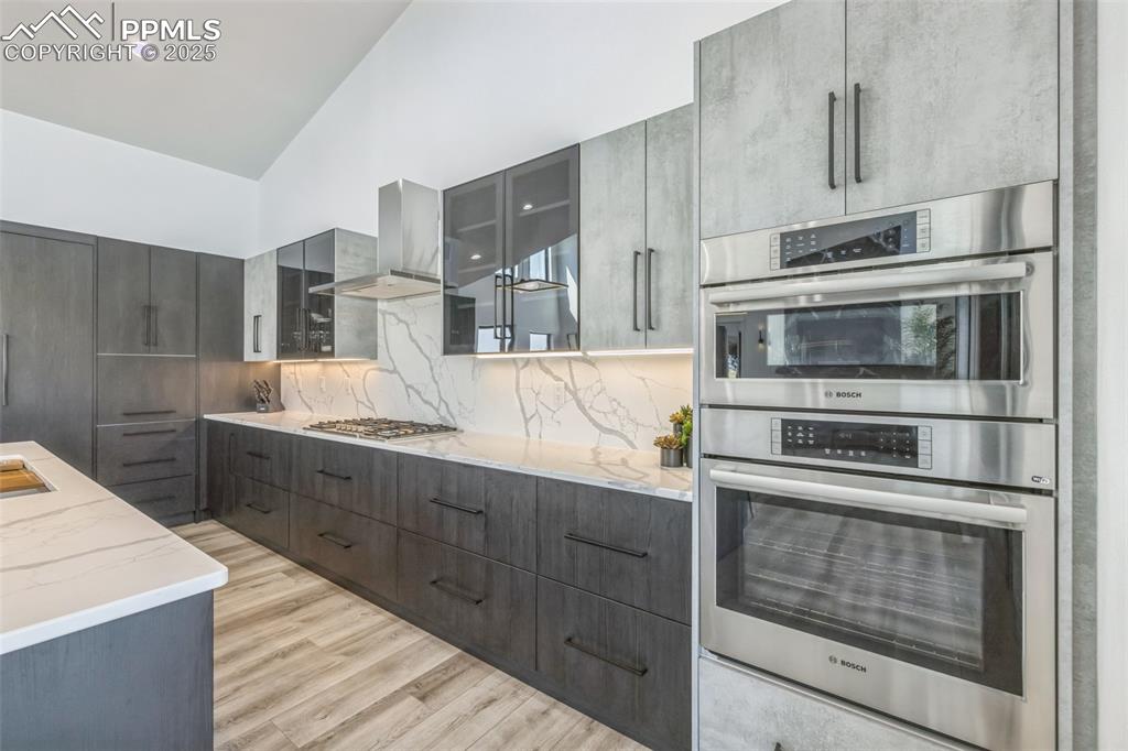 Image 14 of 50: Kitchen featuring appliances with stainless steel finishes, modern cabinets