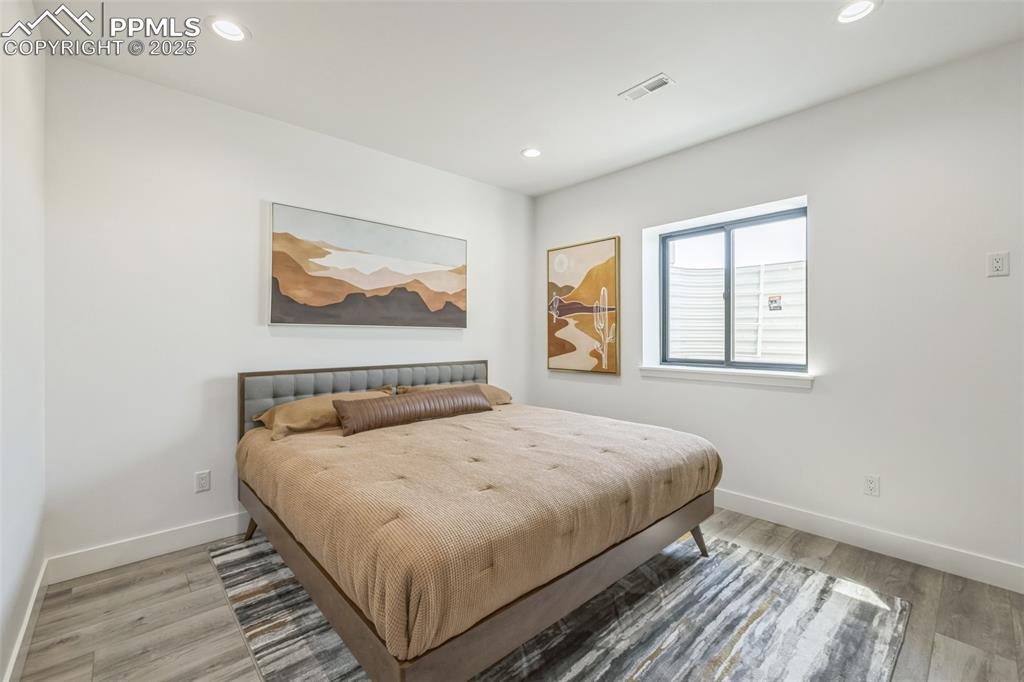 Image 24 of 50: Bedroom with recessed lighting and light wood-type flooring