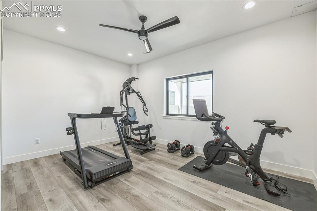 Image 32 of 50: Exercise room with recessed lighting, light wood-style floors, and a ceilin