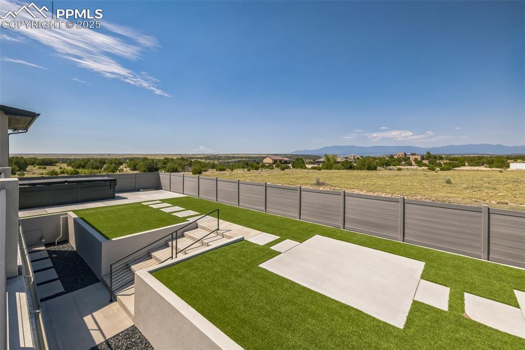 Image 36 of 50: View of yard featuring a patio area, a rural view, and a mountain view