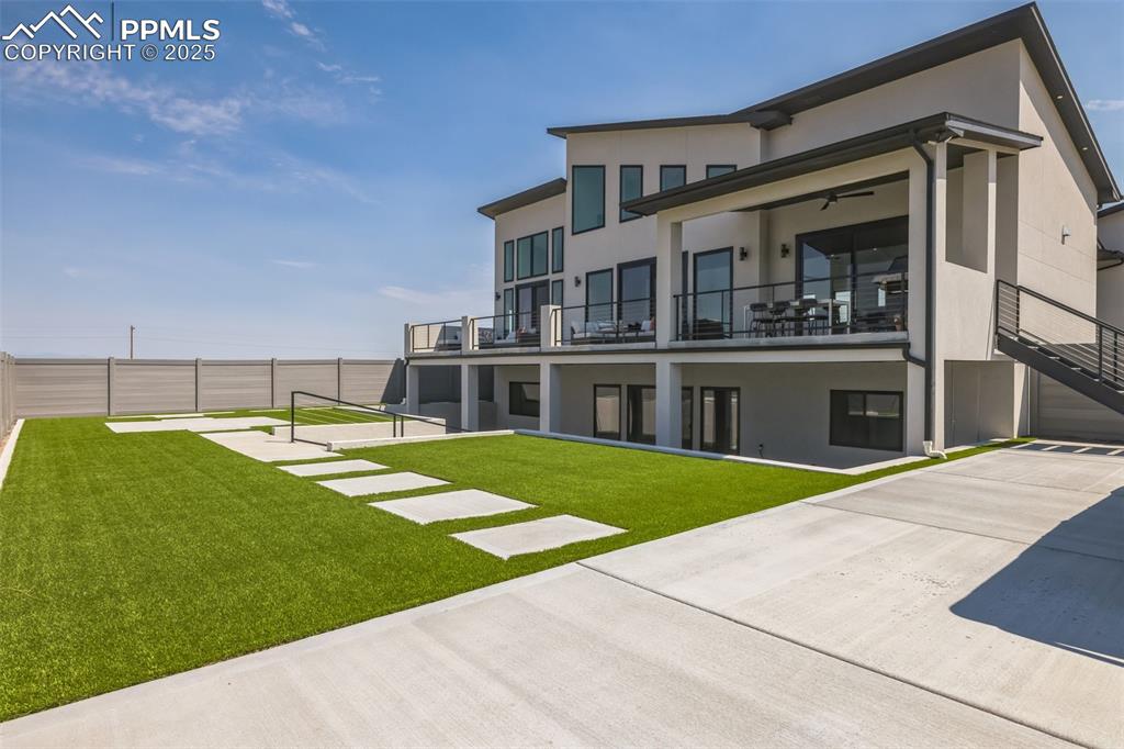 Image 39 of 50: Back of house featuring stucco siding and a balcony
