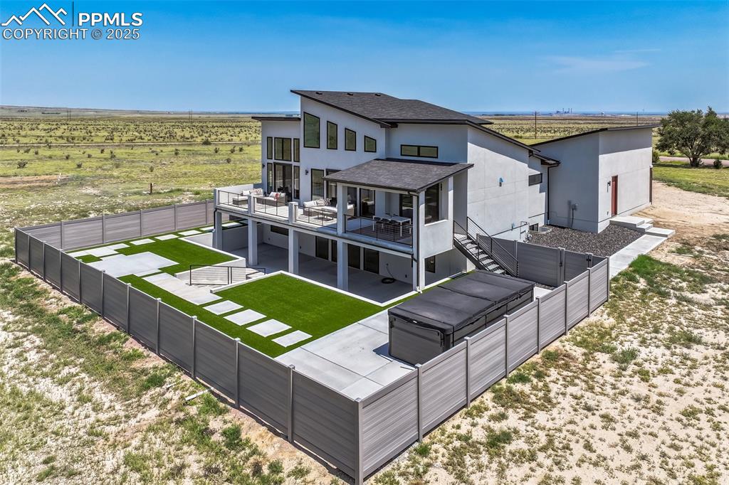 Image 41 of 50: Back of property with a patio, a view of countryside, a fenced backyard, ro