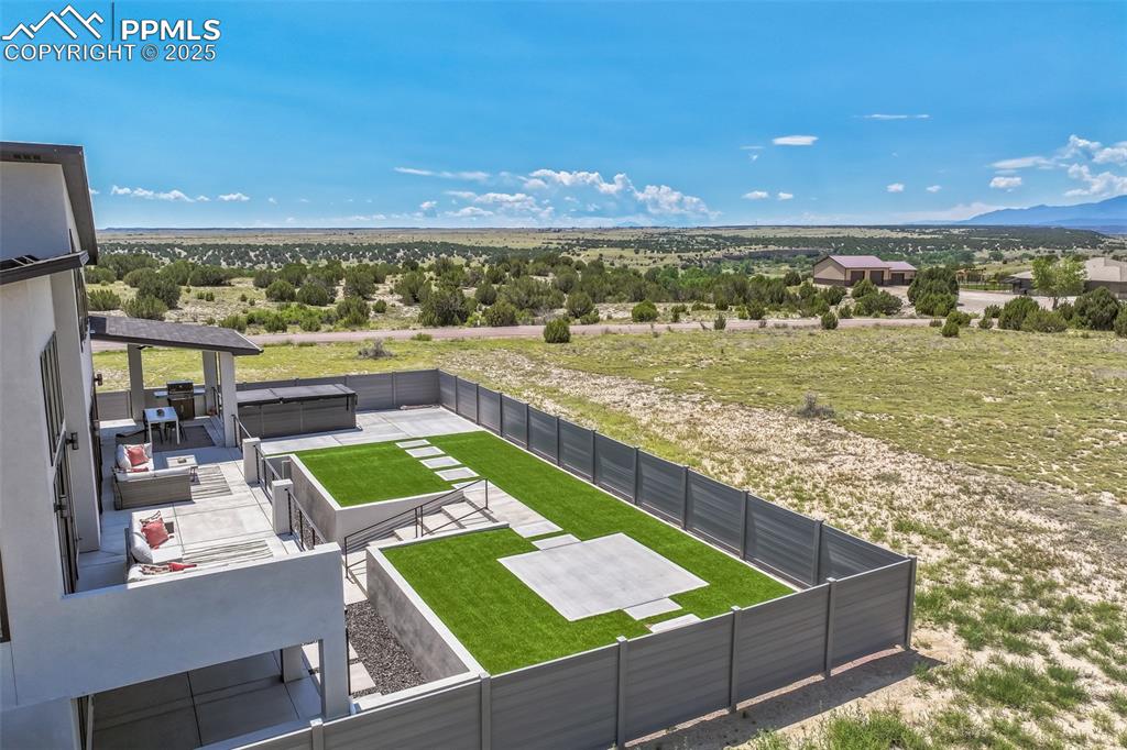 Image 42 of 50: Aerial view of sparsely populated area with a mountainous background