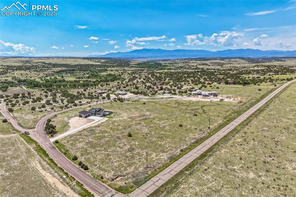 Image 45 of 50: View of rural area with a mountain backdrop