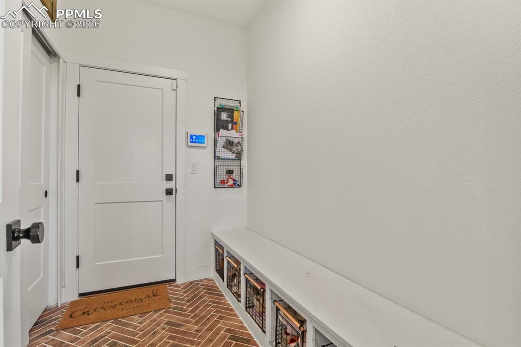 Image 18 of 47: Mudroom with brick floors