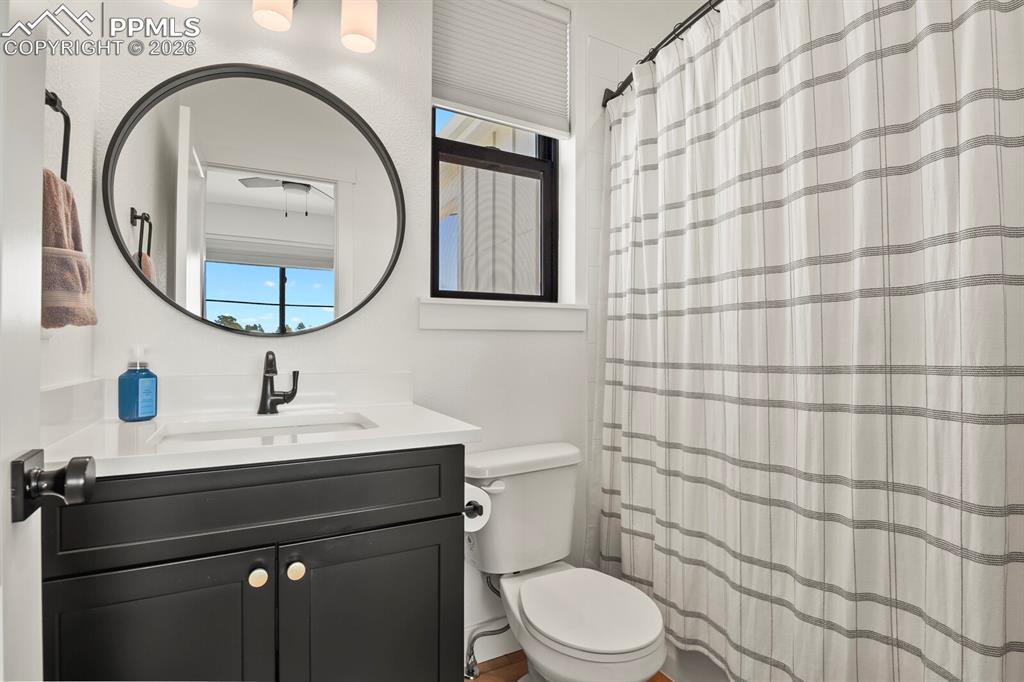 Image 26 of 47: Bathroom with vanity and a shower with shower curtain