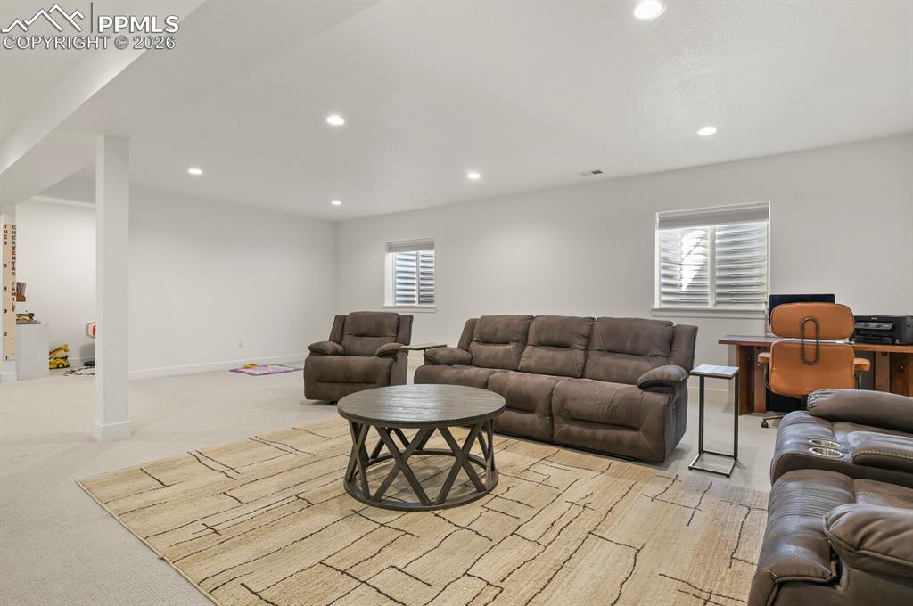 Image 29 of 47: Living room with light carpet and recessed lighting