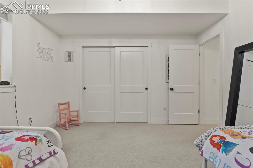 Image 37 of 47: Bedroom with light carpet and a closet
