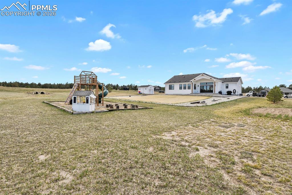 Image 41 of 47: View of grassy yard with a patio area