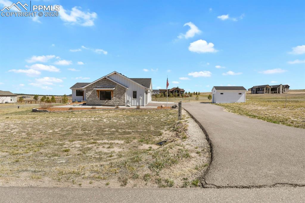 Image 45 of 47: View of front facade featuring an outdoor structure, board and batten sidin