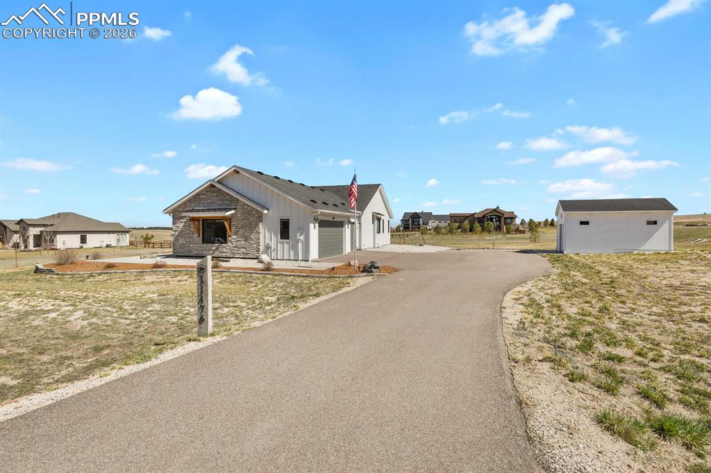 Image 46 of 47: View of front of house with board and batten siding, a residential view, an