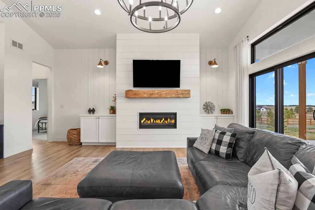 Image 7 of 47: Living area featuring healthy amount of natural light, light wood finished 
