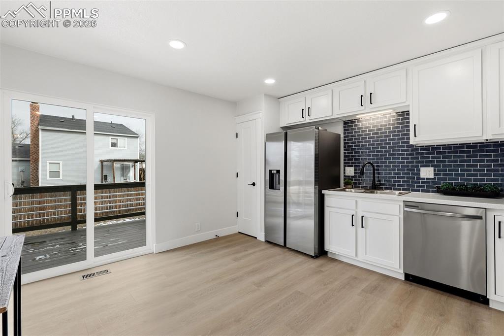 Image 11 of 32: Walk-Out Kitchen to Deck