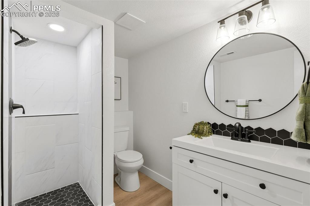 Image 24 of 32: Stylish Bathroom with Upgraded Tile