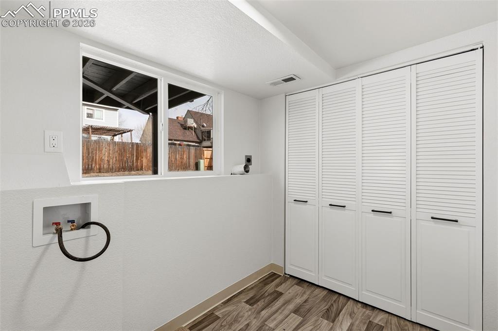 Image 28 of 32: Spacious Laundry Room with Plenty of Storage