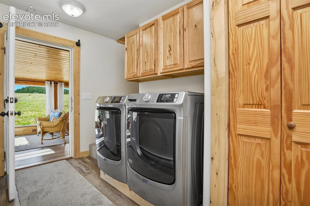 Image 10 of 29: Dedicated laundry area featuring modern appliances