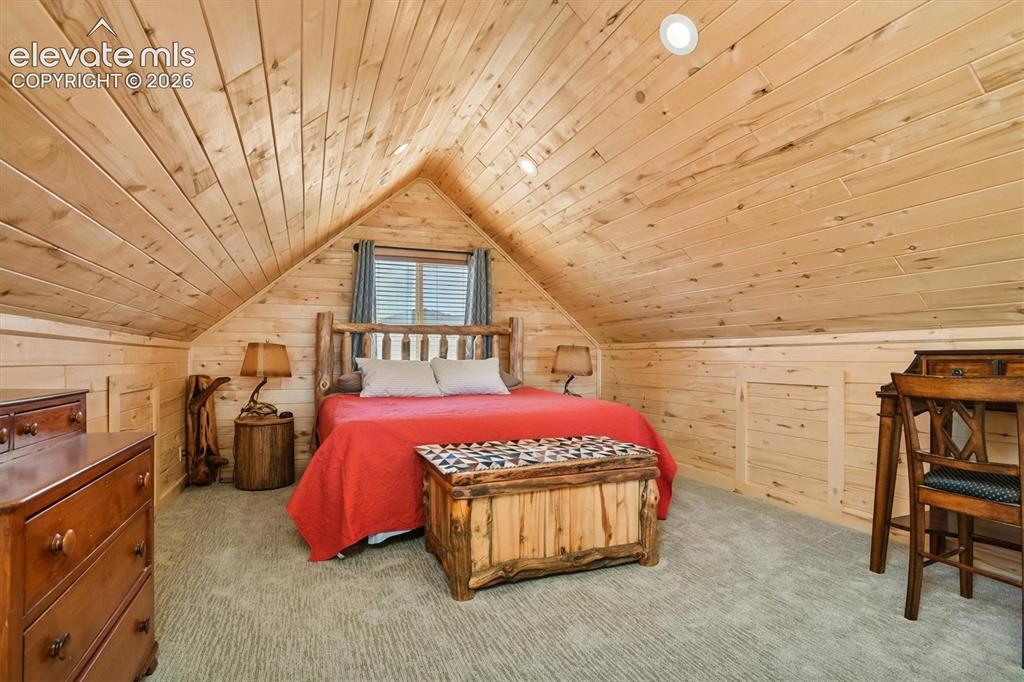 Image 16 of 29: Vaulted wood-paneled ceiling with recessed lighting