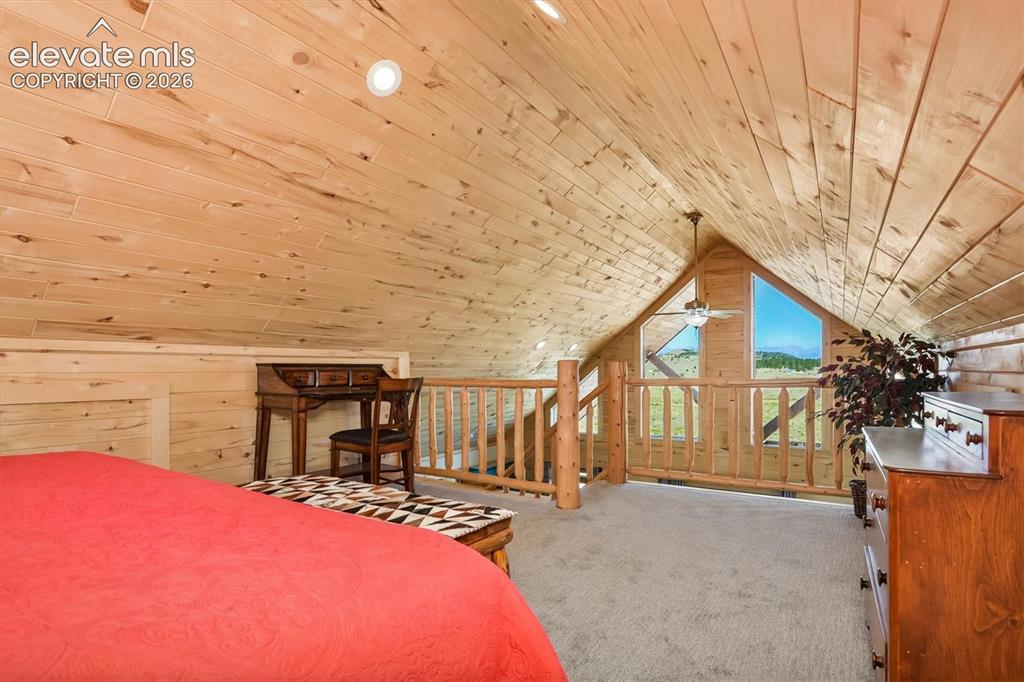 Image 17 of 29: Vaulted wood-paneled ceiling with recessed lighting and a ceiling fan