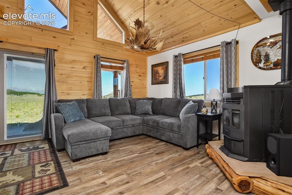 Image 4 of 29: Vaulted ceiling with wood-finish paneling and exposed wood beams