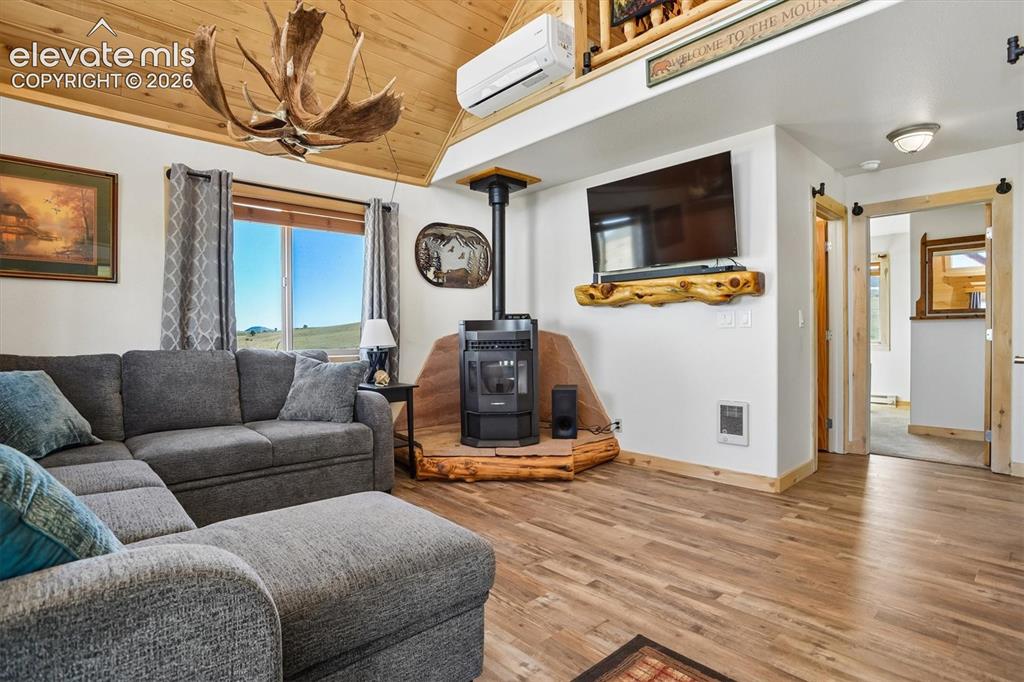 Image 5 of 29: Vaulted wood-paneled ceiling with exposed beams, wood-finish flooring, and 