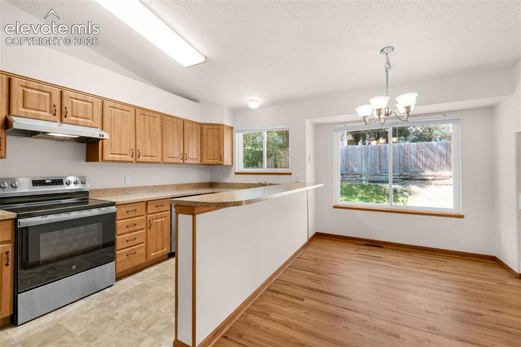 Image 10 of 44: Kitchen eating bar and dining area.