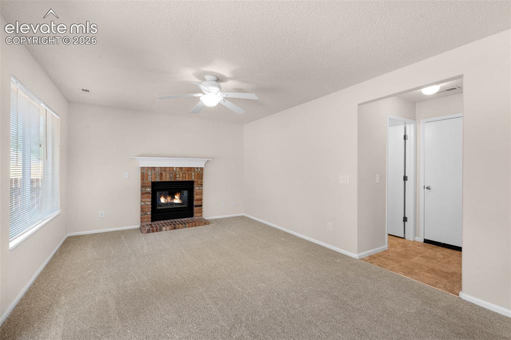 Image 14 of 44: Family room with nice fireplace