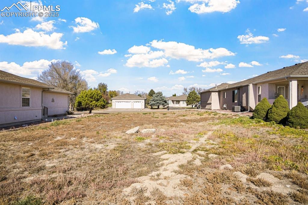 Image 8 of 11: View of yard with a residential view and a detached garage