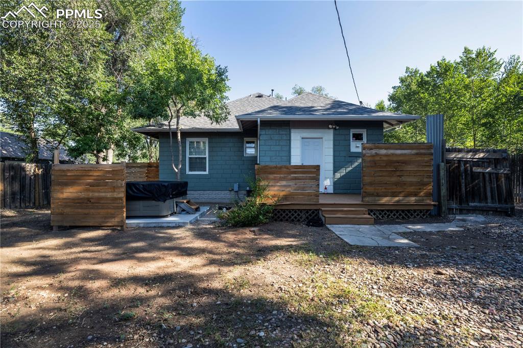 Image 18 of 19: Back of house with a deck, a shingled roof, and a patio