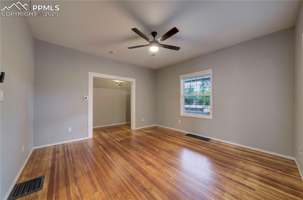 Image 6 of 19: Spare room with hardwood / wood-style flooring and ceiling fan