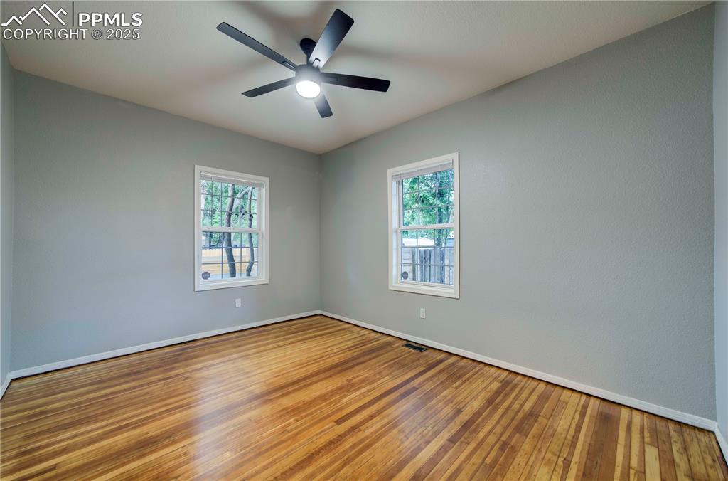 Image 7 of 19: Unfurnished room with wood finished floors