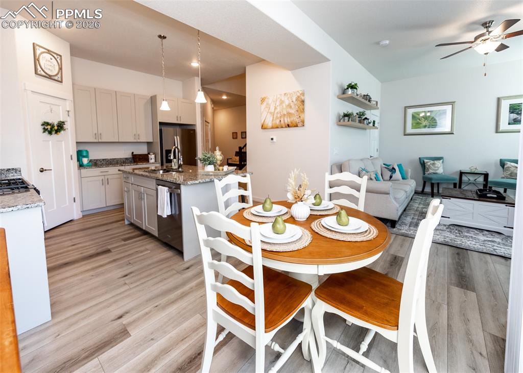 Image 18 of 49: Dining room with a ceiling fan and light wood-type flooring
