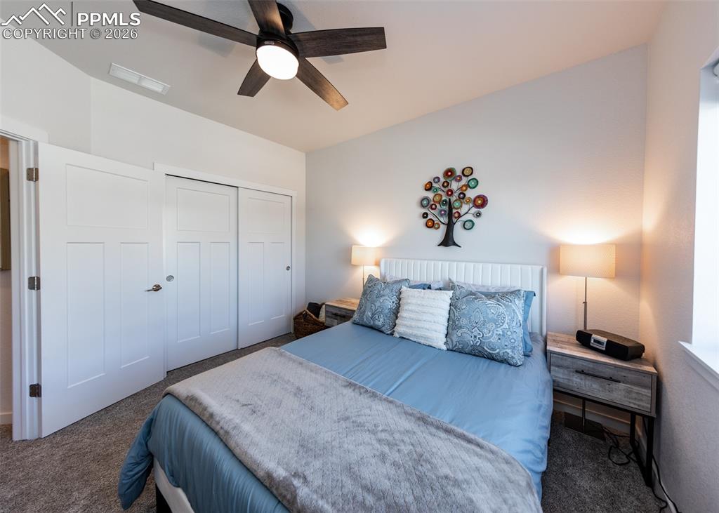 Image 36 of 49: Carpeted bedroom featuring a closet and ceiling fan