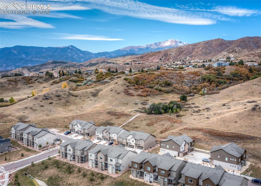 Image 45 of 49: Aerial perspective of suburban area featuring a mountain backdrop