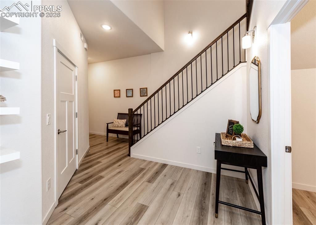 Image 6 of 49: Entryway featuring stairway and light wood finished floors