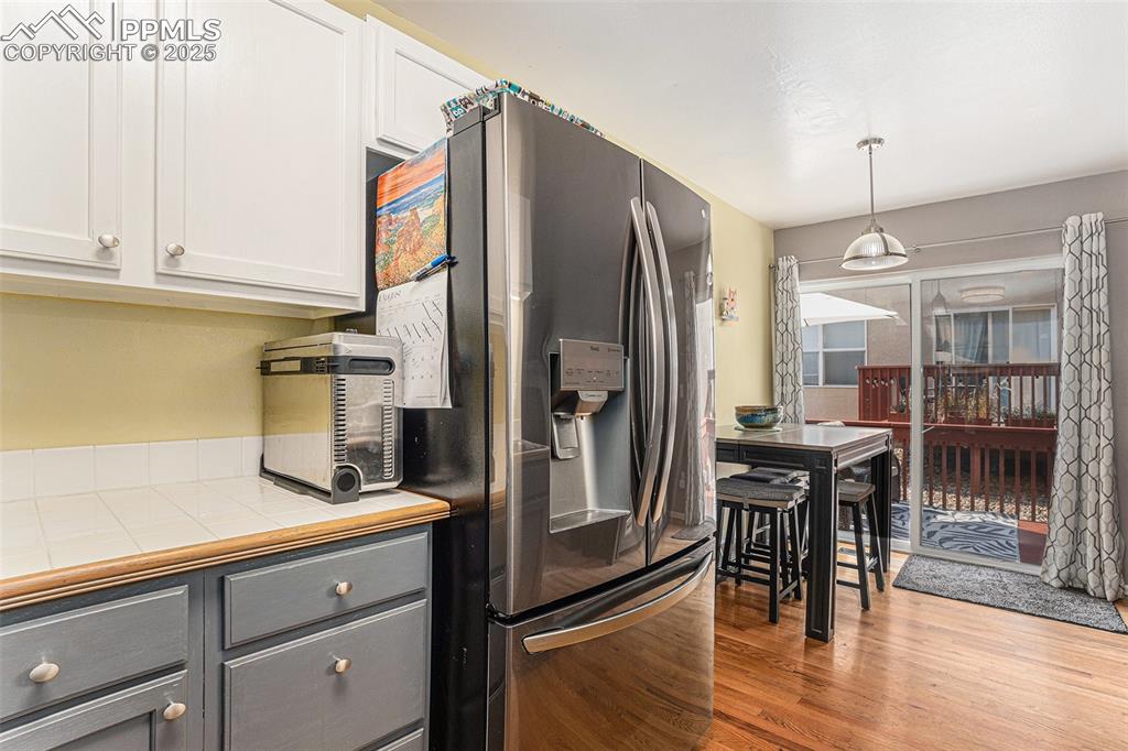 Image 10 of 22: Another view of kitchen and dining areas leading to wood deck for enjoying